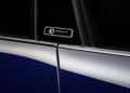 Close-up of a car door with a "40 Jahre Porsche" badge visible between the front and rear windows, featuring a dark blue exterior and chrome trim—a true celebration of Porsche Italia craftsmanship.
