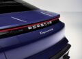 Close-up of the rear of a blue Porsche Taycan 4S, featuring the Porsche logo, Taycan 4S badge, and a sleek red light strip across the trunk—a modern touch in the legacy of icons like the Porsche 911.