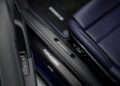 Close-up of a Porsche Italia car's interior showing a blue leather seat, Ferragamo-branded door sill, and Porsche-branded floor mat—luxury touches fit for a Taycan or Porsche 911.