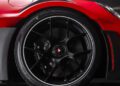 Close-up of a 911 GT3 RS’s rear wheel with a black alloy rim, ventilated disc brake, and aerodynamic fender features at the Porsche Experience Center Toronto.
