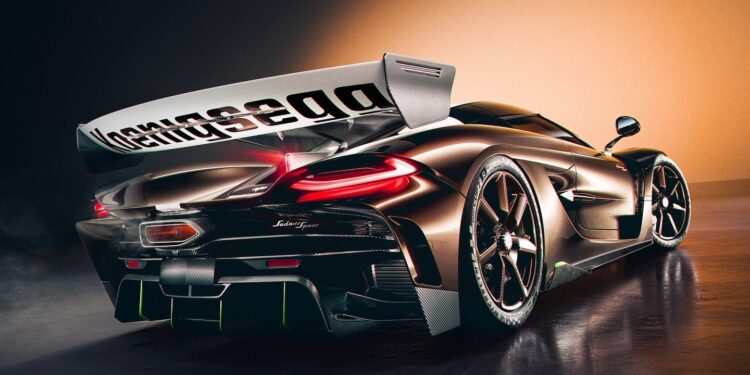A sleek black hypercar with a large rear wing is shown under dramatic lighting, highlighting its aerodynamic design and sporty features—Farewell Jesko, enter the Spear.