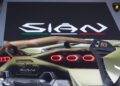 Close-up of the rear end of a Few-Off Lamborghini Sián FKP 37, highlighting hexagonal taillights and rear wing, with the "Sián" logo displayed on a screen during Monterey Car Week.