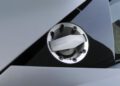 Close-up of a Lamborghini-branded fuel cap on a metallic gray car, with clean lines and geometric reflections in the background—captured during Monterey Car Week for this Few-Off masterpiece.