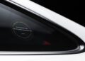 Close-up of a sticker on a car window reading "Porsche Sonderwunsch 2021 Exclusive Manufaktur" on a white vehicle, seen at the Porsche Experience Center.