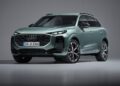 A green 2026 Audi Q3 SUV breaks cover in a studio with a plain gray background, viewed from the front left side.