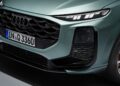 Close-up of the front end of a green 2026 Audi Q3 Breaks Cover: Here's What's New vehicle, highlighting the grille, headlight, and license plate reading "IN Q 3360.