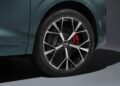 Close-up of the 2026 Audi Q3 Breaks Cover: Here's What's New—showing its rear wheel with a silver alloy rim, five-double-spoke design, and a striking red brake caliper.