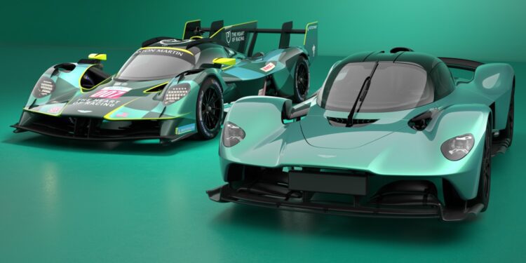 Two teal Aston Martin hypercars, including the Valkyrie AMR LMH set to make its Le Mans debut, are showcased side by side—one in race-ready form with sponsor decals and the other in a sleek road car version.