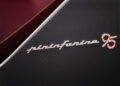 Close-up of a car panel featuring the "pininfarina 95" logo in chrome lettering on a dark textured background, celebrating the exclusivity of the Battista Novantacinque.