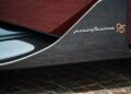 Close-up of a car panel with a "pininfarina 95" badge on carbon fiber, highlighting the Pininfarina Battista Novantacinque special edition design.