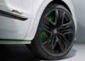Close-up of a black Bentley Bentayga Speed wheel with green brake caliper on a white car; the "Speed" badge is visible above the powerful Bentayga’s wheel.