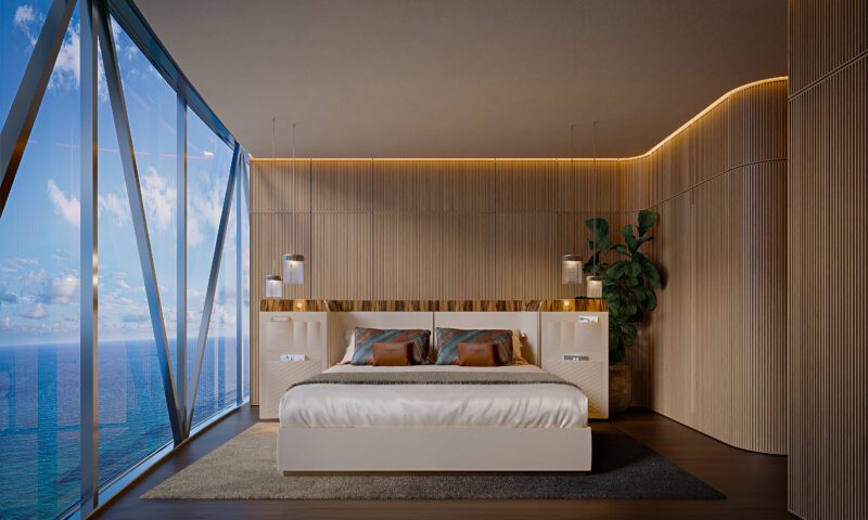Modern penthouse bedroom with wood paneling, large bed, pendant lights, a plant in the corner, and floor-to-ceiling windows overlooking the ocean at Bentley Residences Miami.