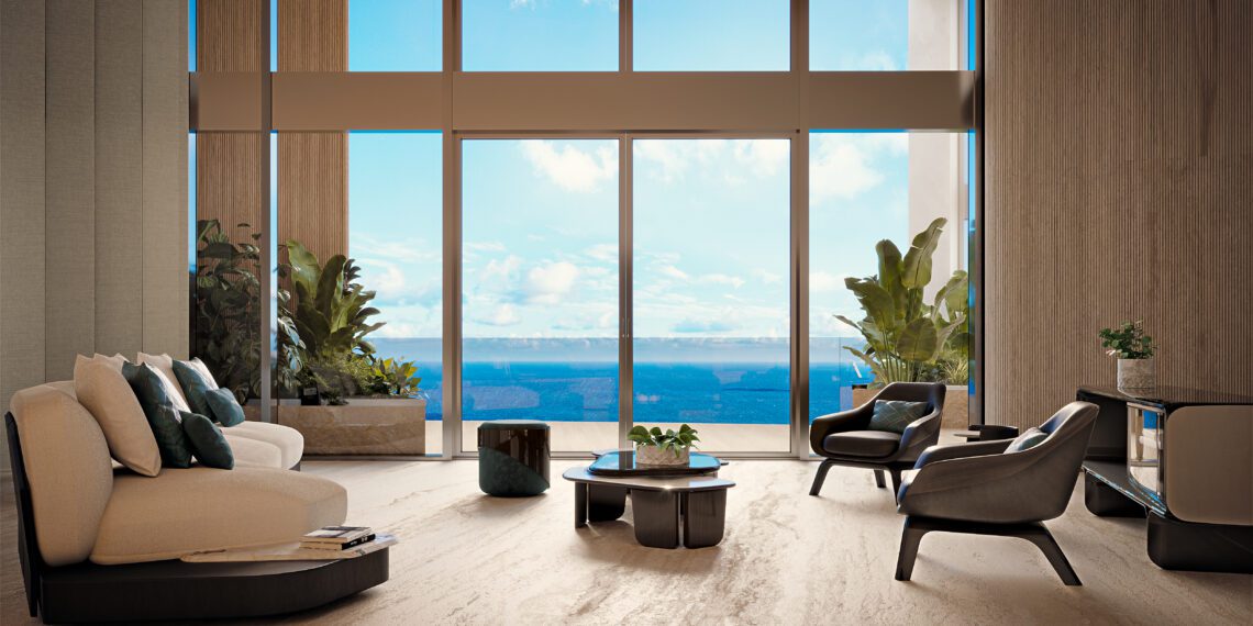 Modern penthouse living room with large floor-to-ceiling windows, beige sofas, elegant chairs, potted plants, and a stunning ocean view under a blue sky—an exquisite example of Miami real estate at Bentley Residences Miami.