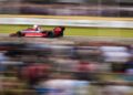 A red Parmalat-branded Formula 1 car races past blurred spectators at the Festival of Speed, creating a dynamic sense of speed and motion.