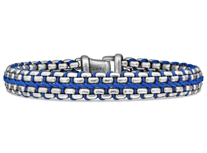 A bracelet with two rows of silver metal links woven with blue cord, featuring a silver clasp in the center—an ideal choice for Father's Day gifts from the duPont REGISTRY Father's Day Gift Guide.