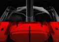 Transparent and red-toned views of a racing yacht hull are shown from above and below, revealing structural details and lines against a black background, emphasizing performance inspiration reminiscent of the Ferrari Hypersail.