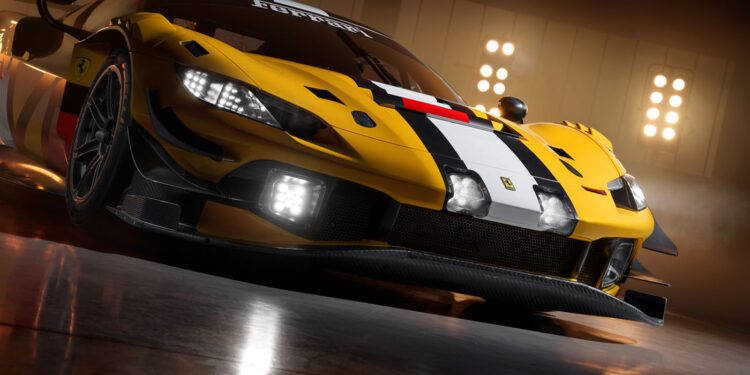 A yellow Ferrari 296 GT3 Evo race car with black and white striping is parked indoors under bright lights, viewed from a low front angle, capturing the spirit of the 24 Hours Of Spa.