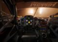 Interior view of a Ferrari 296 GT3 Evo race car cockpit, featuring a steering wheel with multiple buttons, digital display, control panel, and safety netting—engineered for endurance events like the 24 Hours Of Spa.