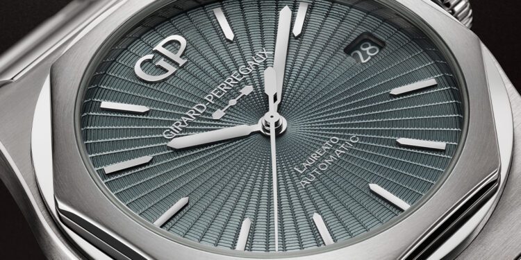 Close-up of a Girard-Perregaux Laureato 50th Anniversary watch featuring a textured blue dial, silver hands and indices, date display at 3 o'clock, and a sleek stainless steel case.