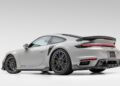 A silver sports car with a rear spoiler and black wheels is shown from a rear-side angle against a plain white background, embodying the bold spirit of Gunther Werks Goes Modern: Meet GW9’s Carbon-Clad 992 Turbo S.
