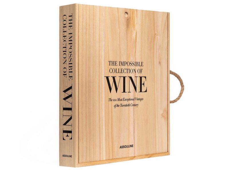 A wooden box with black text that reads "The Impossible Collection of Wine" and "The 100 Most Exceptional Vintages of the Twentieth Century" by Assouline—a standout selection for Father's Day gifts in the duPont REGISTRY.