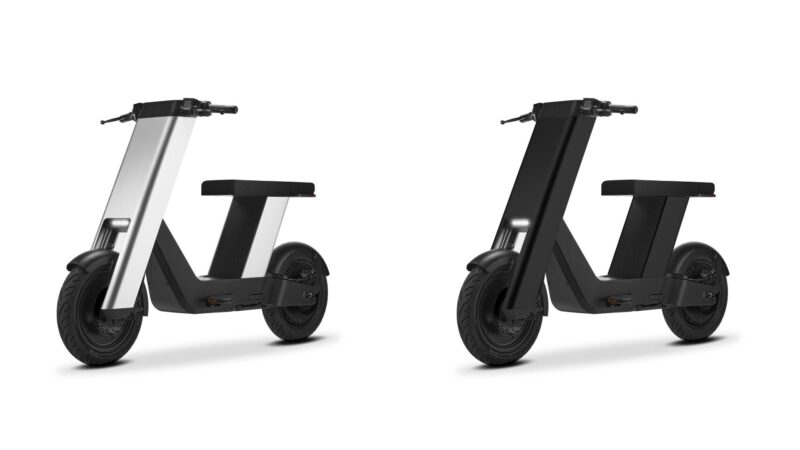 Two modern Olto electric scooters are shown side by side, one in white and the other in black, both with minimalist angular designs by Infinite Machine, set against a white background—ready to glide down any bike lane.