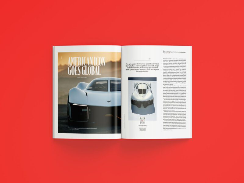 An open duPont REGISTRY magazine, dated July 2025, rests on a red surface with an article titled "American Icon Goes Global" and images of a white sports car featured across both visible pages.