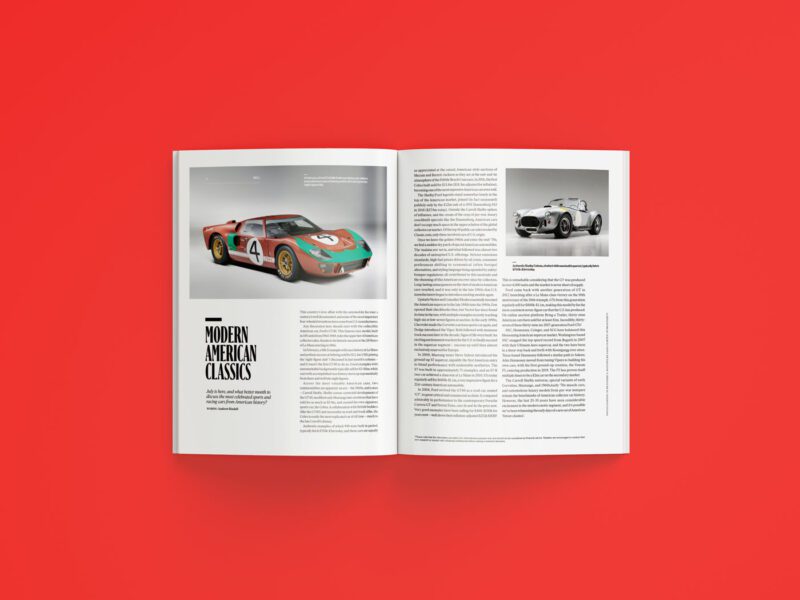 An open duPont REGISTRY magazine, July 2025 issue, rests on a red surface displaying articles and photos of classic cars—a race car on the left page and a vintage car on the right.
