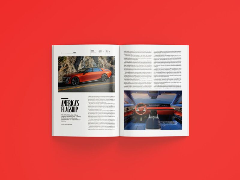 An open duPont REGISTRY magazine on a red surface displays two pages featuring a red car, with exterior and interior images and accompanying text about the vehicle in the July 2025 issue.