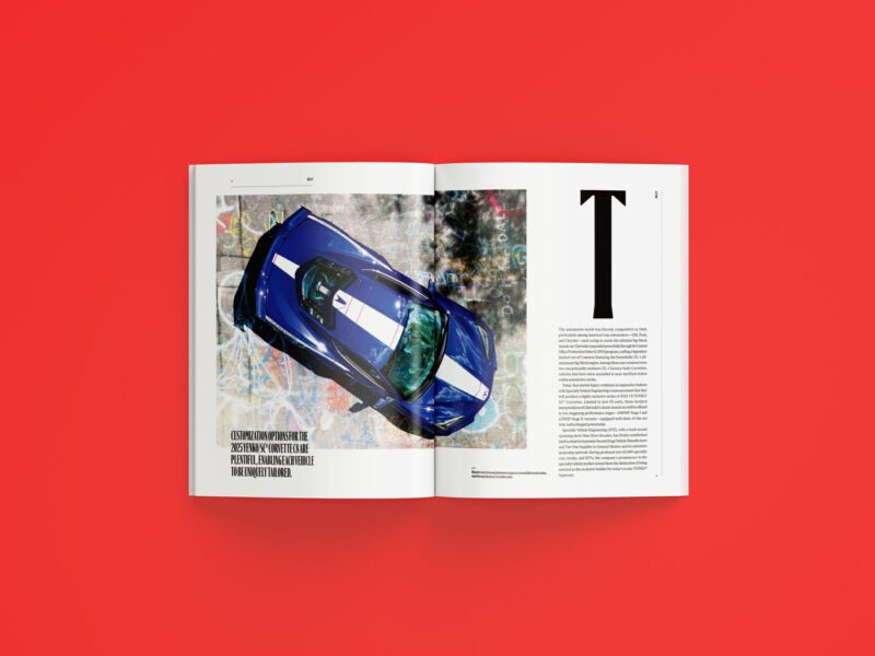 An open magazine, possibly the June 2025 issue of duPont REGISTRY, rests on a red surface, displaying a top-view photo of a blue sports car with white stripes and a page of text with a large capital letter "T.