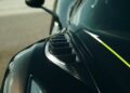 Close-up of a black sports car's front fender, highlighting aerodynamic vents and a yellow accent stripe—an homage to the Farewell Jesko: Enter Track-Focused 1625 HP Koenigsegg Sadair's Spear.