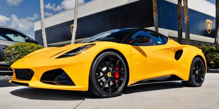 A yellow sports car with black wheels, for sale as the best sports car under $100k, is parked outside a modern building with palm trees in the background.