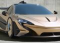 A matte gold McLaren P1 EVO-inspired sports car with a large rear wing, aerodynamic design, and blue accents, styled by Frank Stephenson, parked on a concrete surface against a plain wall.