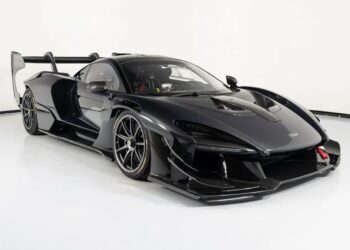 A black McLaren Senna sports car is parked in a white studio, showcasing its aerodynamic design and prominent rear wing—one of the most expensive supercars among McLaren cars.