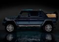 A blue Mercedes-Maybach G650 for sale, this luxury SUV features four doors and an open tan convertible top, parked on a reflective surface against a dark background.