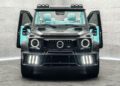 A customized black SUV with turquoise interior, open front doors, LED lights on both bumper and roof, displayed indoors against a gray tiled wall.