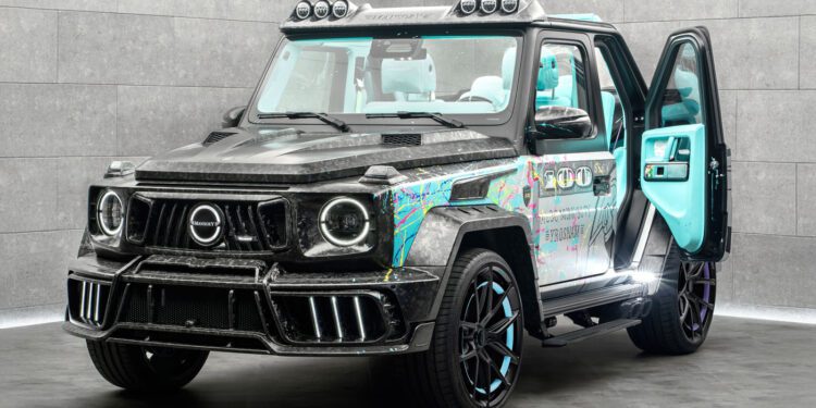 A customized Mansory G-Wagon with a carbon fiber body, colorful graphic accents, black wheels, and a turquoise interior, parked indoors with the driver's door open.