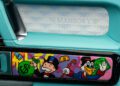 Detail of a G-Wagon car door interior with turquoise accents, MANSORY branding, and cartoon art by Alec Monopoly featuring Monopoly Man and Scrooge McDuck holding money bags.