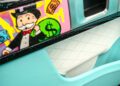 Close-up of a Mansory G-Wagon door interior, showcasing white quilted leather and a vibrant panel with Alec Monopoly’s Rich Uncle Pennybags, money symbols, and graffiti-style art.