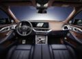 Interior view of the 2026 BMW XM showcases a modern digital dashboard, central touchscreen, luxurious leather seats, and a multi-function steering wheel.