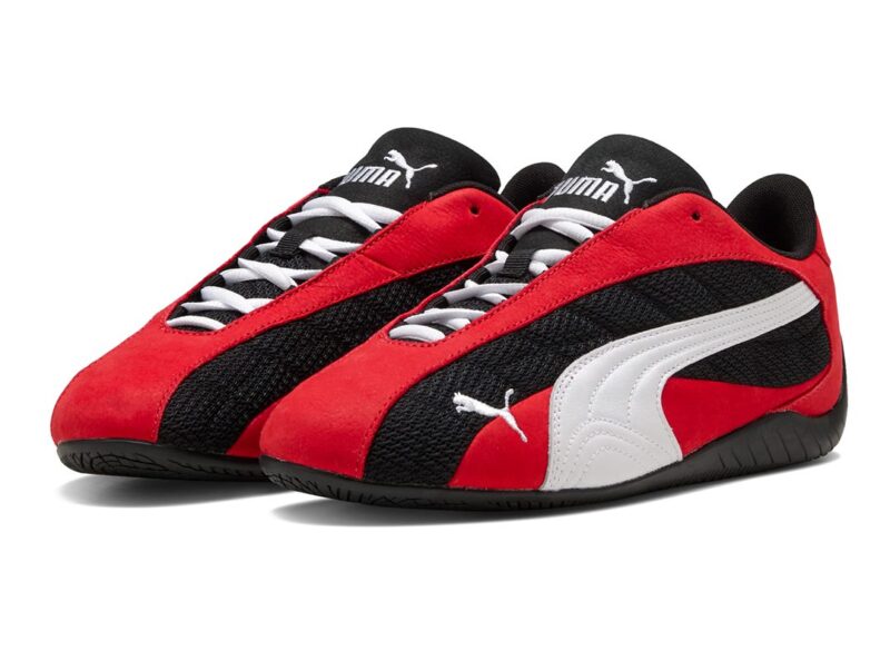 A pair of Puma sneakers with red suede, black mesh, white Puma stripes, and white laces on a black rubber sole—perfect for the Father’s Day Gift Guide featured in duPont REGISTRY.