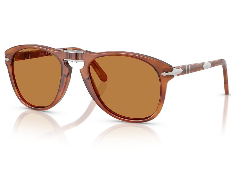 Brown sunglasses with amber-tinted lenses, silver accents on the hinges, and a partially transparent frame, featured in the duPont REGISTRY Father's Day Gift Guide—an exceptional choice for a stylish dad.