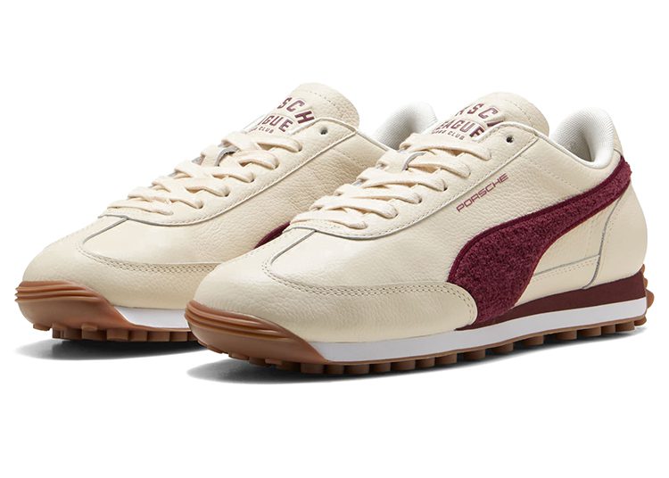 A pair of cream-colored PUMA sneakers with maroon accents, gum rubber soles, and "Porsche" branding on the side—perfect for motorsport enthusiasts and inspired by driver style.