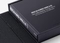A large black coffee table book titled "Richard Mille: The Impossible Collection" sits inside an open black presentation box on a white background.
