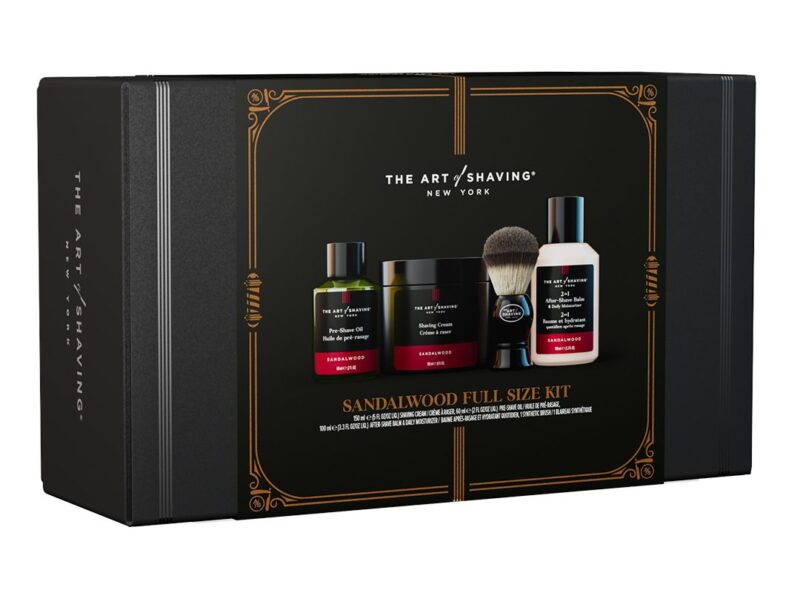 A black box labeled "The Art of Shaving Sandalwood Full Size Kit" containing shaving products: pre-shave oil, shaving cream, after-shave balm, and a shaving brush—an ideal pick from the duPont REGISTRY Father’s Day Gift Guide.