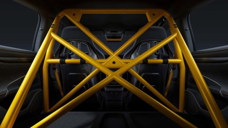 Interior view of a Four-Door EV with a yellow roll cage structure installed behind the front seats, emphasizing safety and reinforcement features inspired by Nürburgring-ready hypercars.
