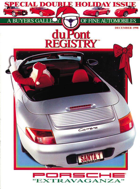 A person in a Santa suit sits in a silver Porsche Carrera convertible with a "SANTA 1" license plate, featured as one of the Cover Cars on the December 1998 duPont REGISTRY magazine cover.