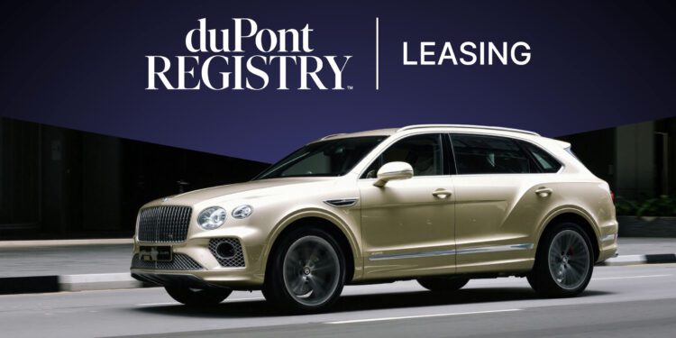A gold luxury SUV drives in front of a dark blue background with "duPont Registry Leasing" text displayed above, highlighting exceptional car leasing options for exotic vehicles.