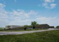 Modern, low-profile building with a dark exterior—this new production facility for Bugatti Tourbillon is surrounded by grass, trees, and a curved driveway under a partly cloudy sky.