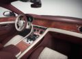 Luxury car interior featuring diamond-stitched leather seats, a leather-wrapped steering wheel, and wood veneer trim—hallmarks of Bentley craftsmanship with exclusive Mulliner interior options.